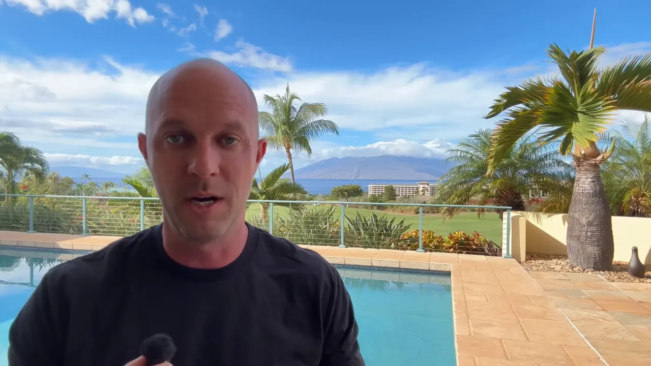 Balanced poolside scene showing resort grounds, golf lawn and ocean behind a speaker