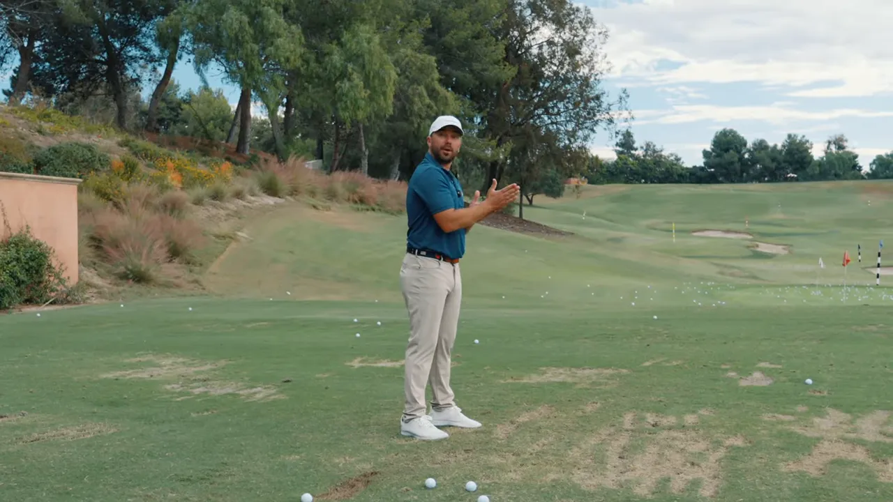 Golf instructor facing the camera demonstrating the 'set, turn, go' sequence on a driving range