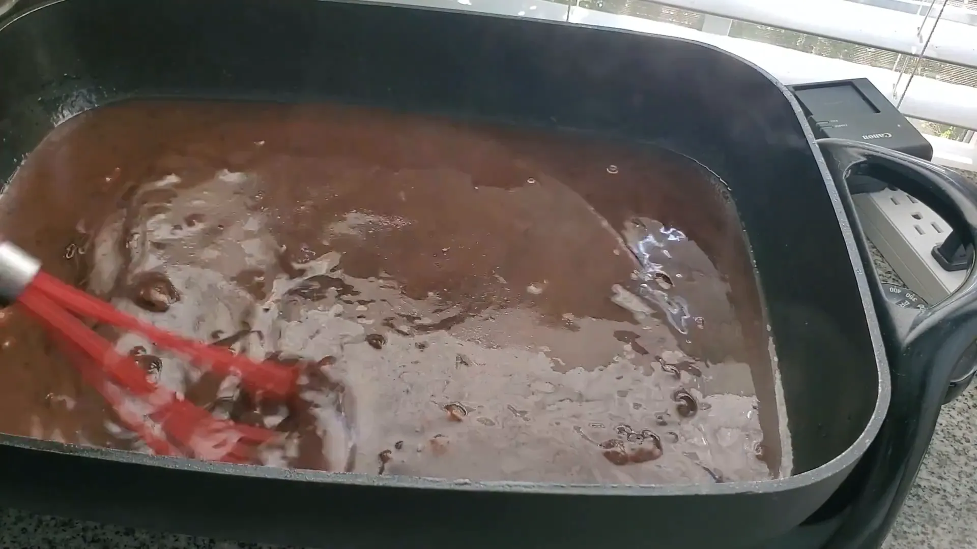 Tasting and seasoning the gravy.