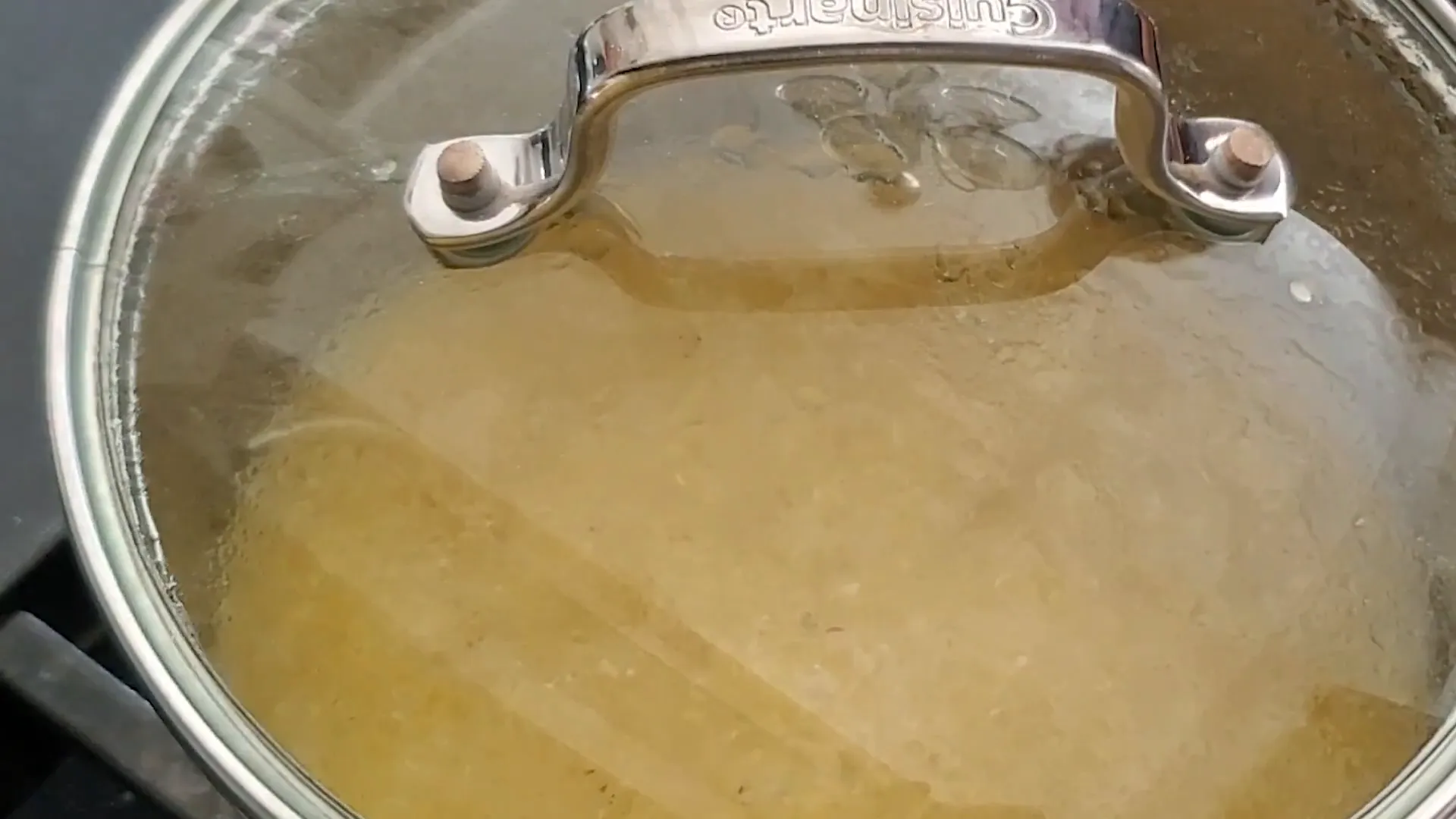 Adding half-and-half to the grits.