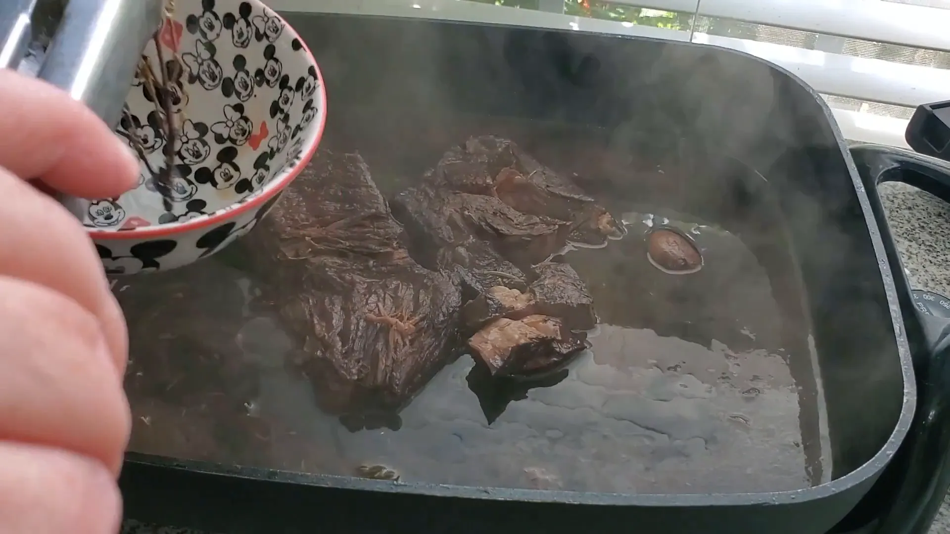 Removing herbs from the pot.