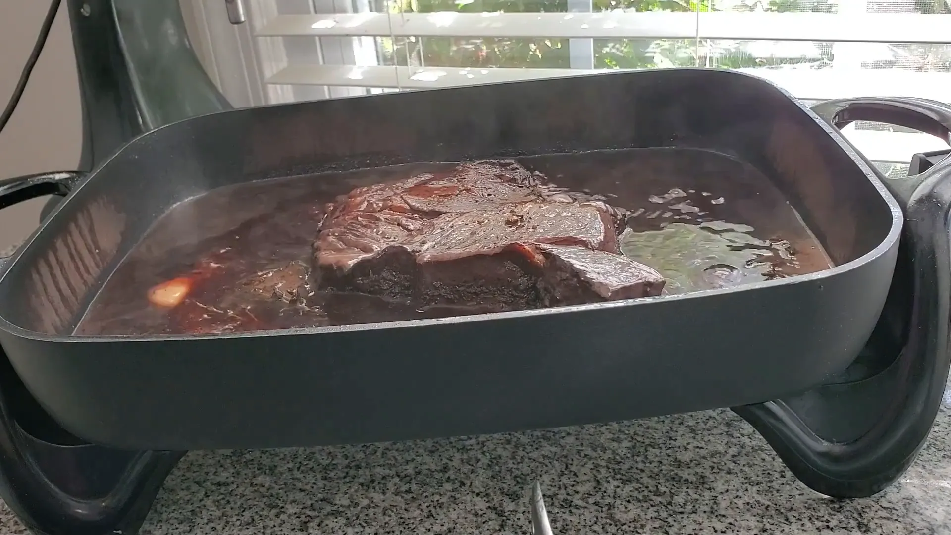 Checking the tenderness of the roast.