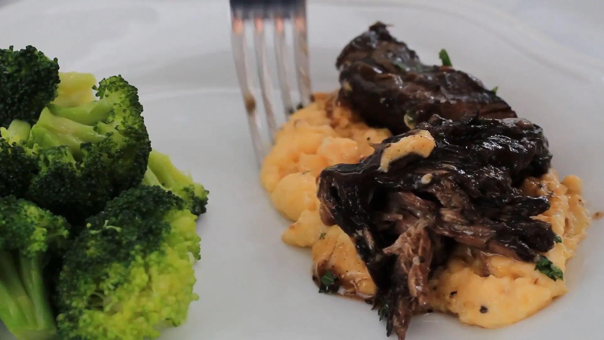 Drizzling gravy over the pot roast.
