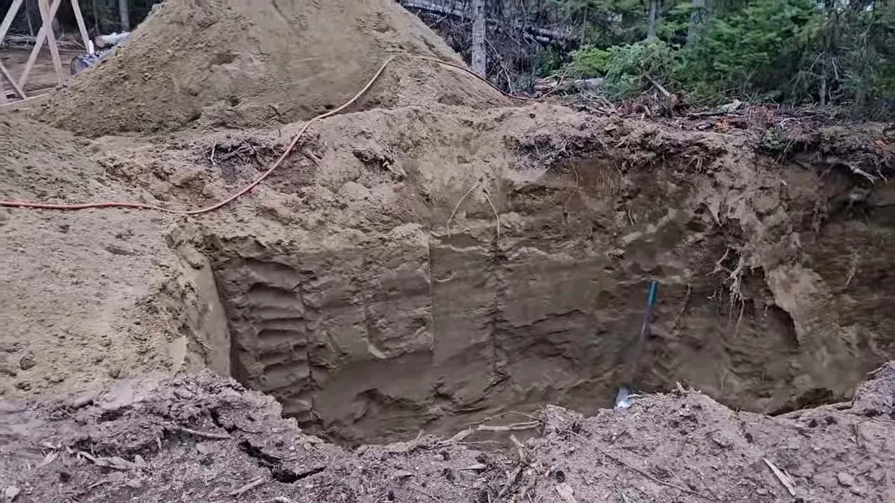Off grid life - close view of the excavation interior with layered sandy walls and cut slopes