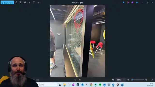 Vertical glass waterfall test installation with water flowing across the glass panel