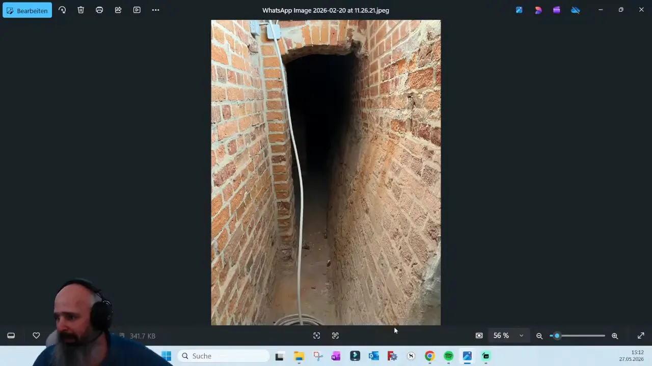 Photo of a narrow below-ground brick drainage access corridor in the project technical area