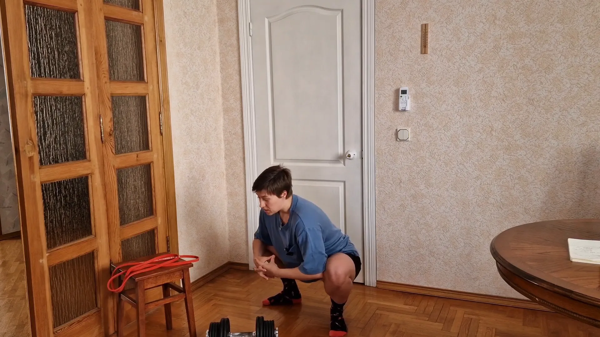 Performing bodyweight deep squat stretch with elbows pushing knees out