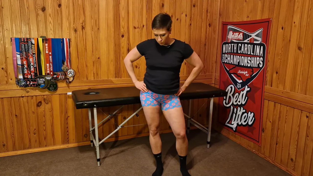 Person standing with hands on hips demonstrating pelvic tilt and weight shift for hip awareness