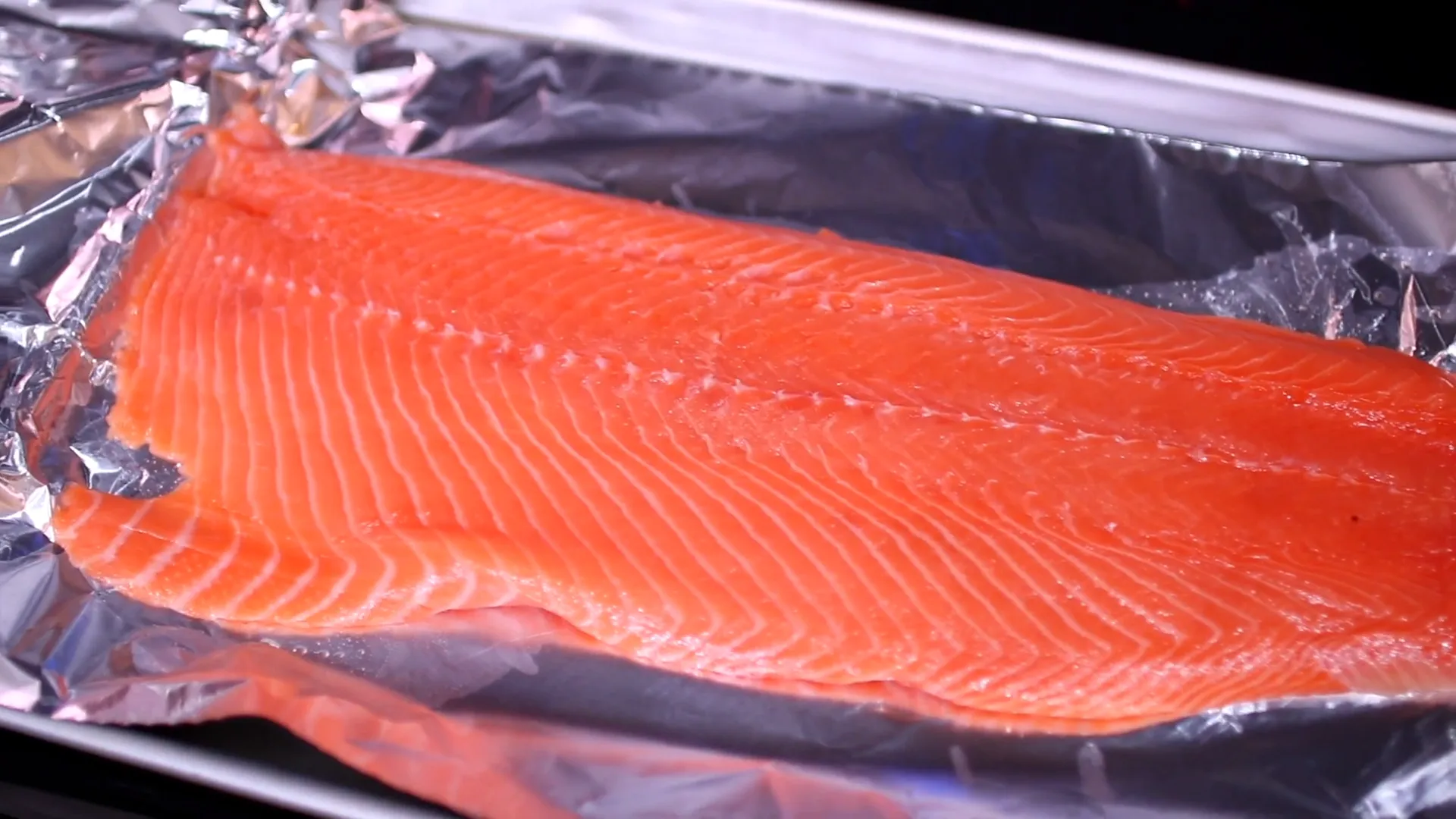 Salmon on a baking pan lined with aluminum foil