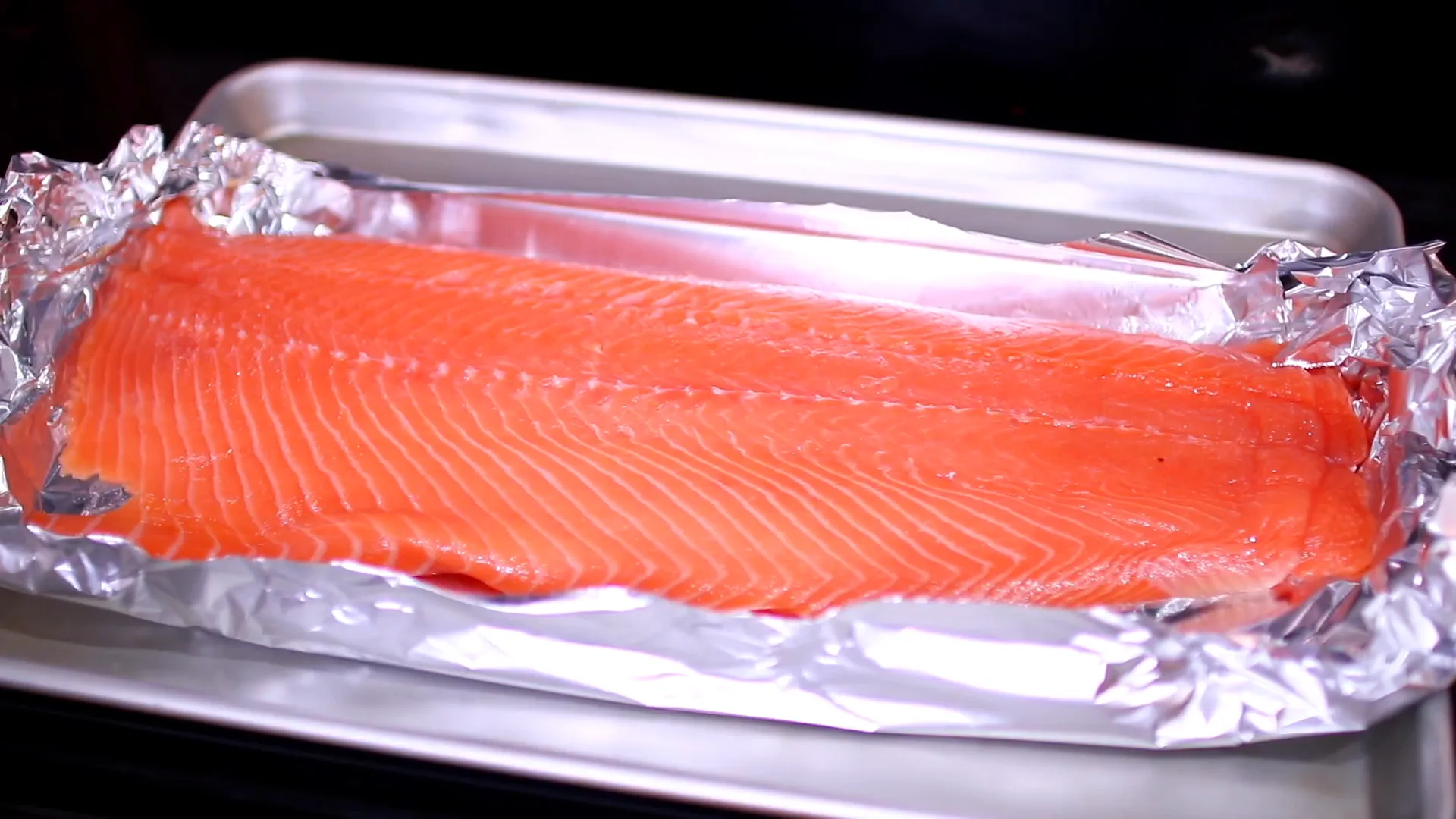 Crimping the edges of the foil around the salmon