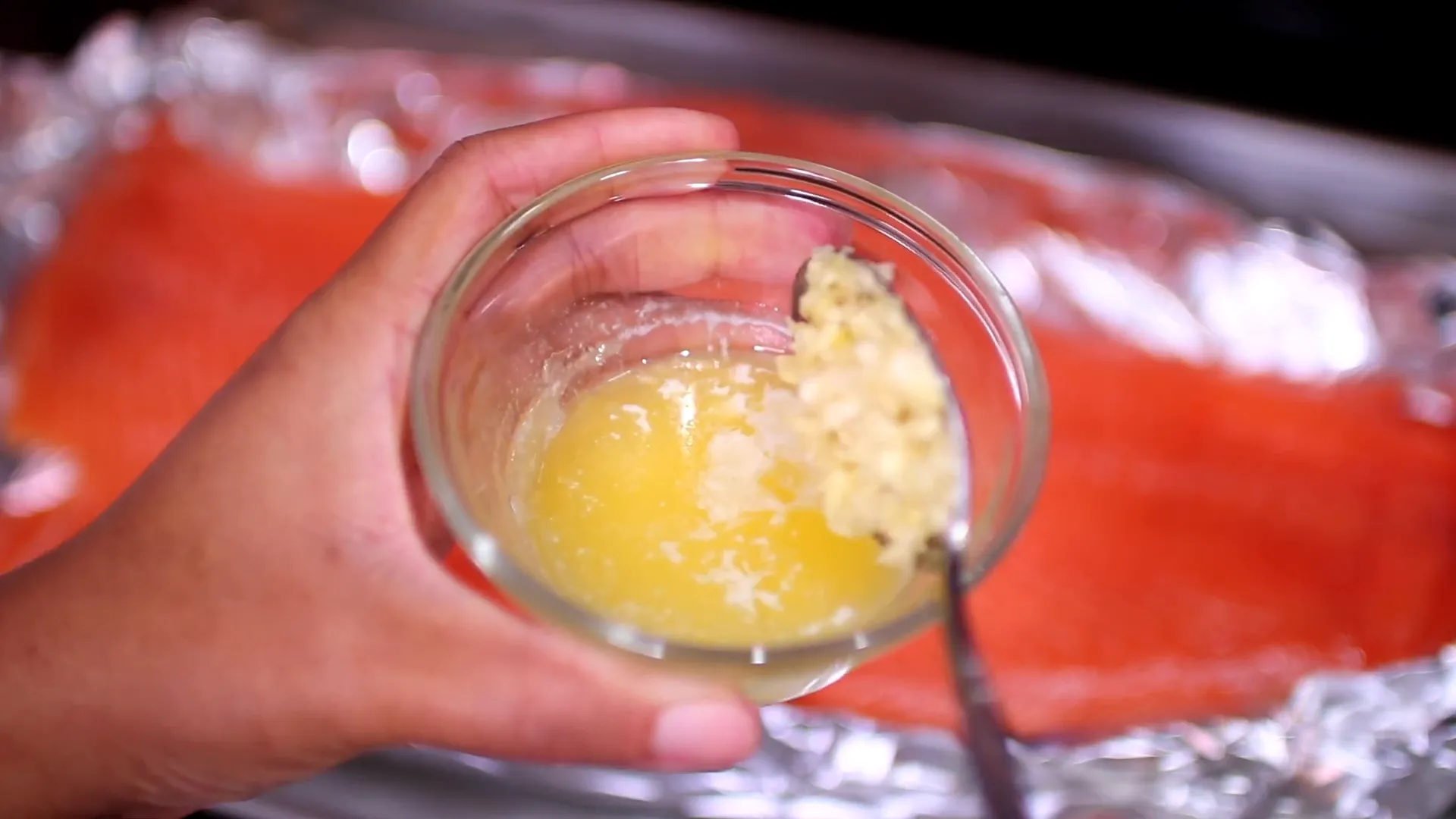 Mixing melted butter and minced garlic