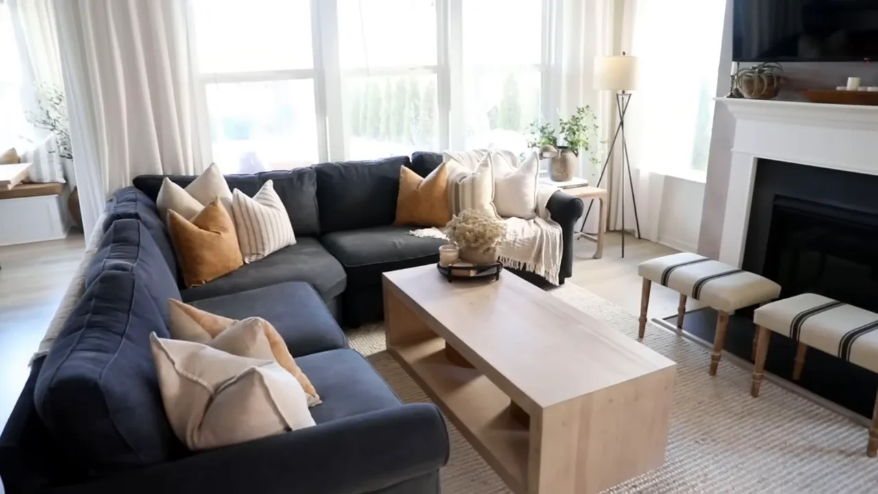 Bright living room with dark sectional sofa and light wood coffee table