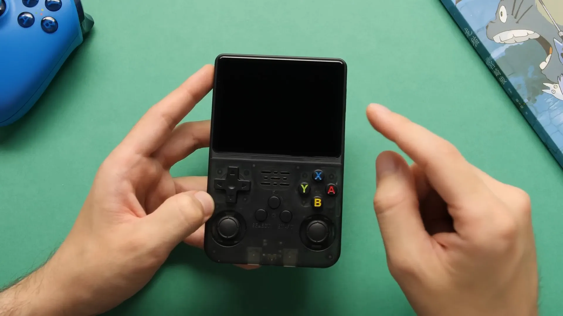 Close-up of R36S device showing screen and buttons