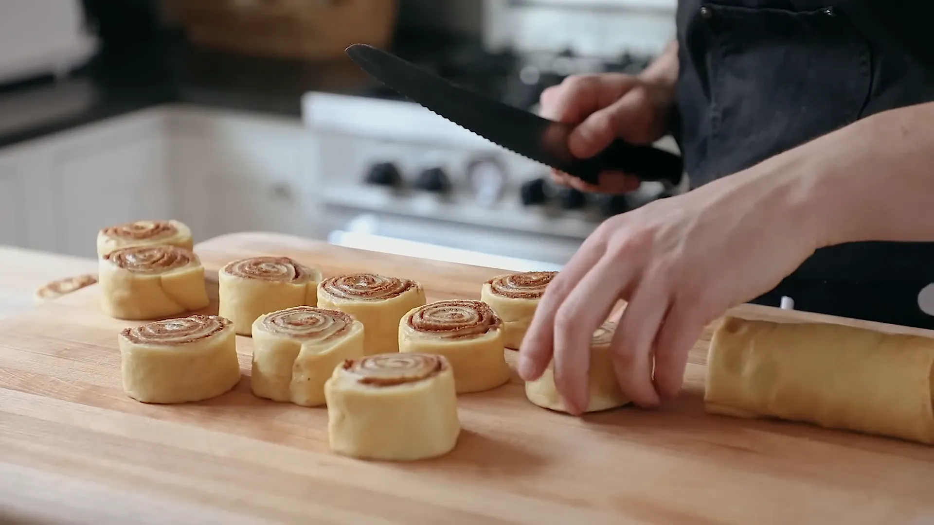 Arranging cinnamon rolls in a baking dish.