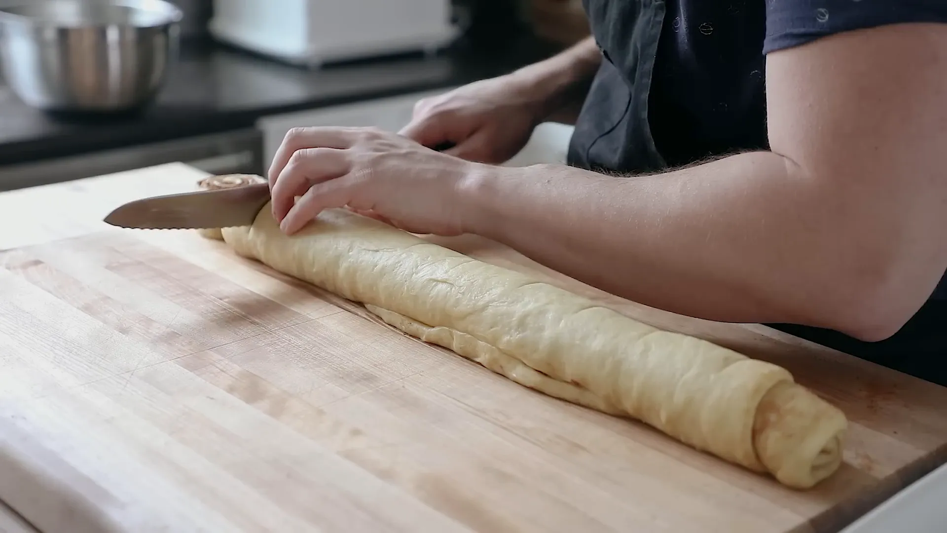 Cutting the rolled dough into slices.