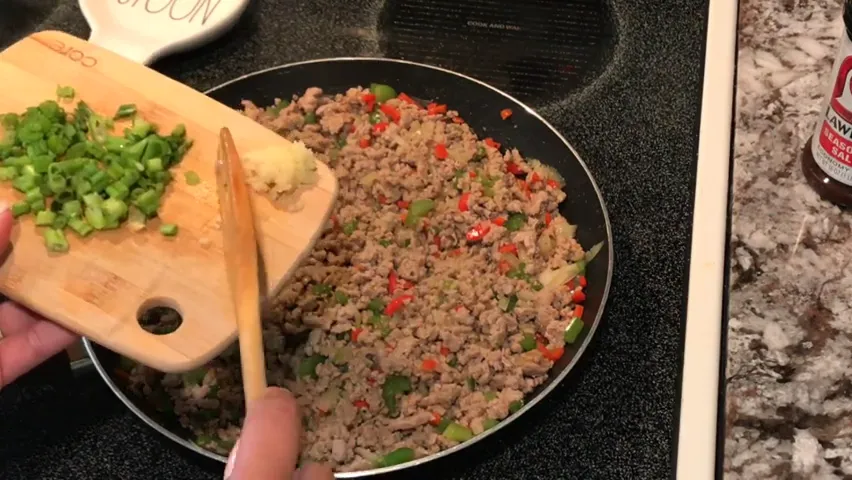 Adding minced garlic to the mixture