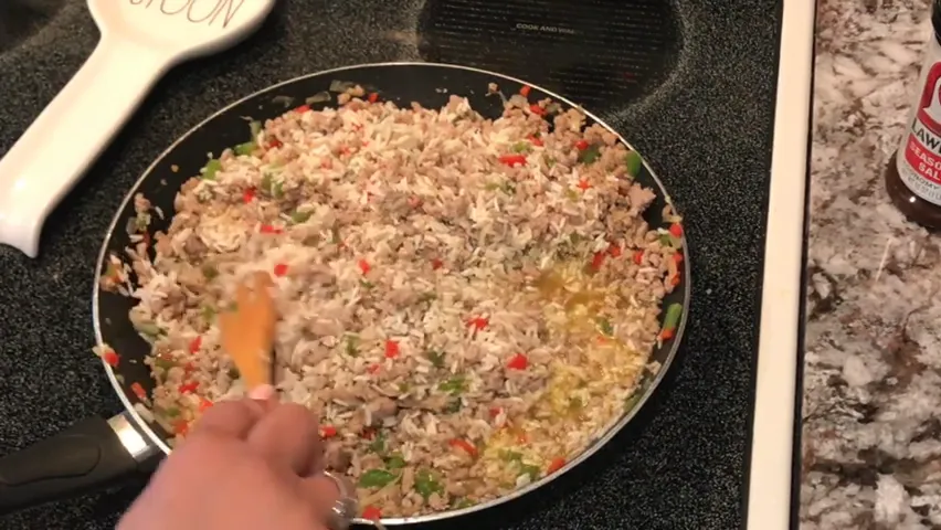 Covering the skillet to steam the rice