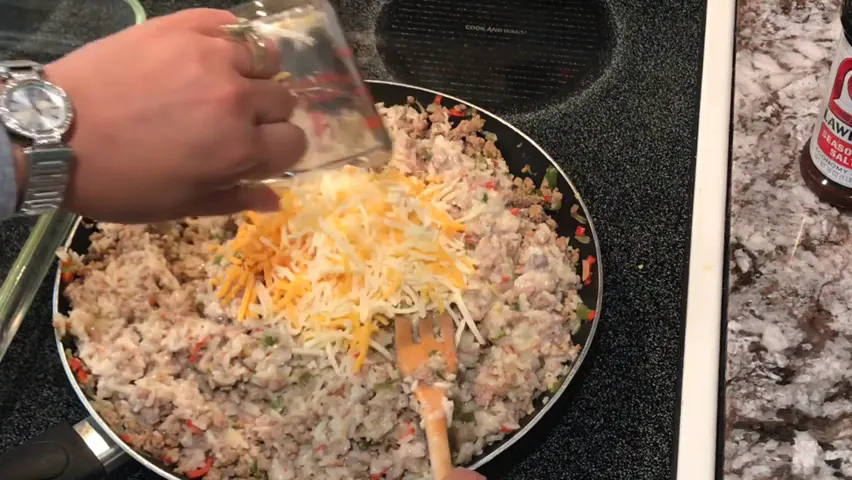 Mixing in cheese to the casserole