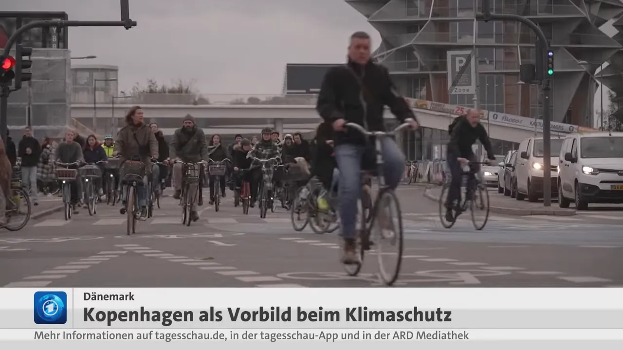 Viele Menschen fahren mit dem Fahrrad über eine Kreuzung in Kopenhagen