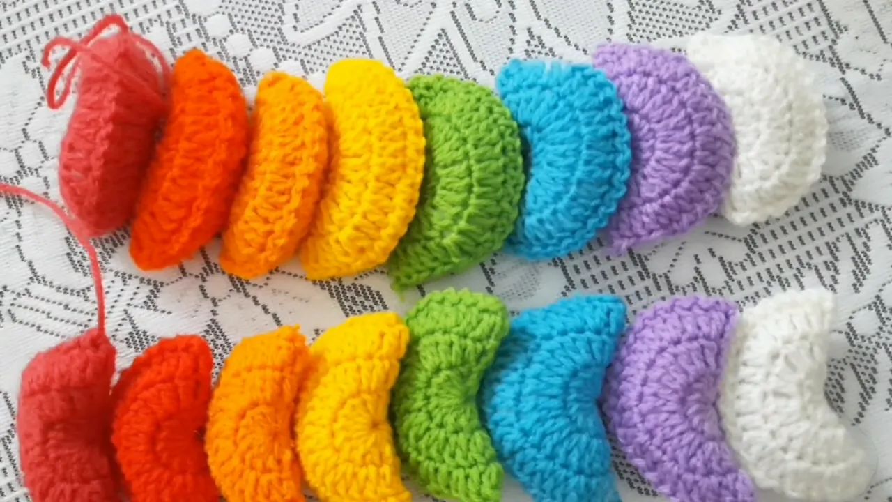 Two rows of stuffed crochet semicircles arranged in matching color sequences