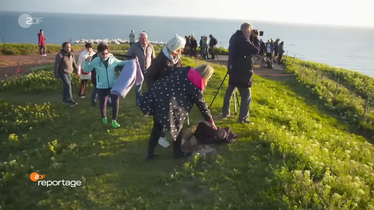 Touristen und Fotografen auf der Düne von Helgoland nahe Klippen