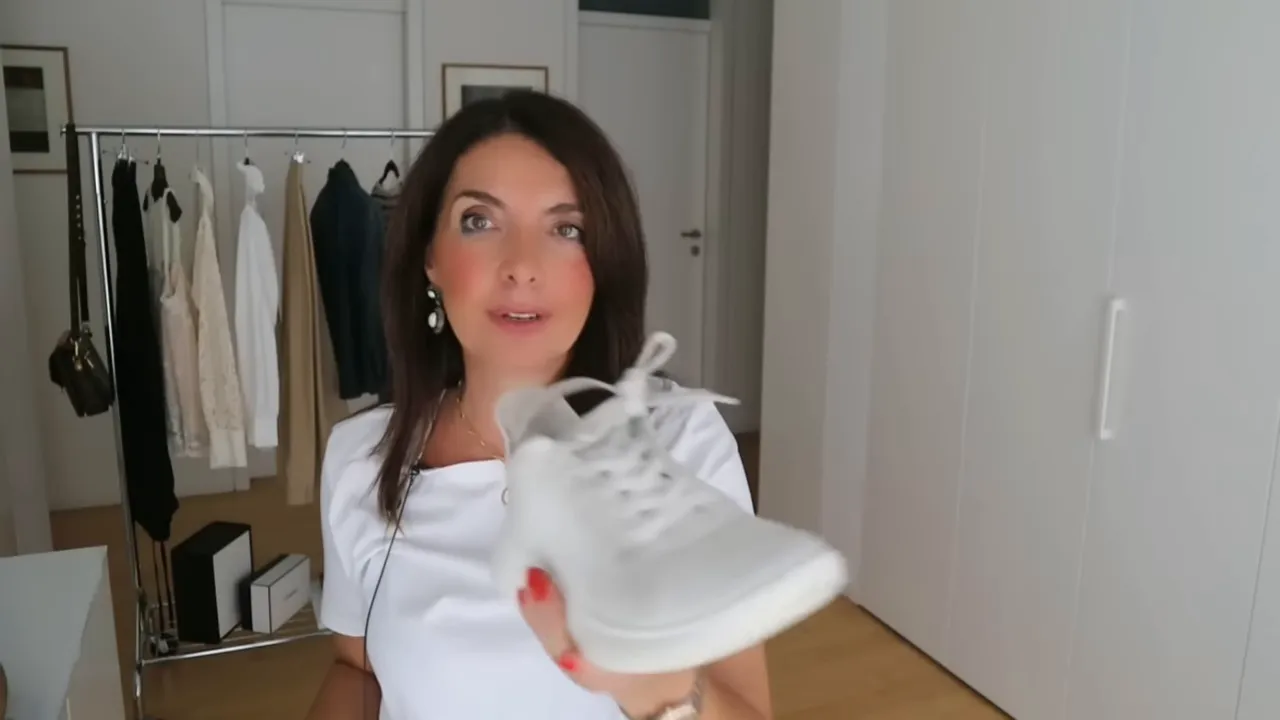 white sneaker held up close to camera