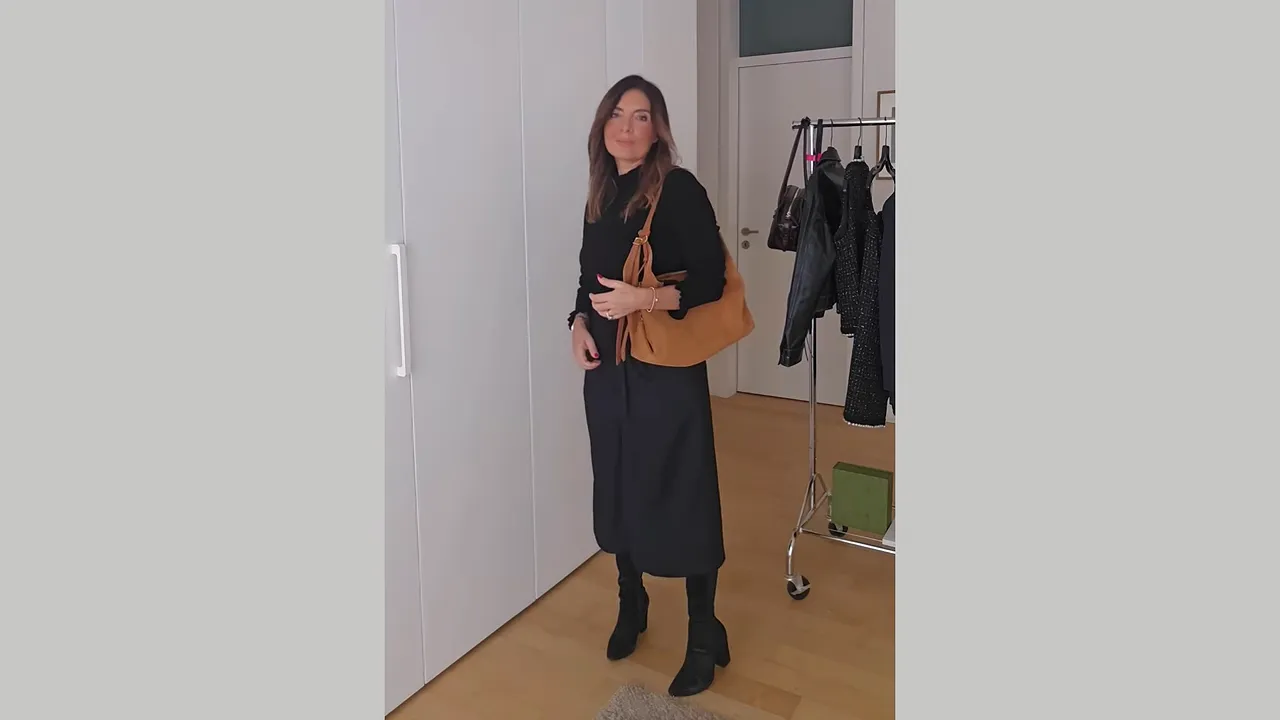 Black cropped wide-leg trousers styled with a fitted black top, tall boots, and brown shoulder bag