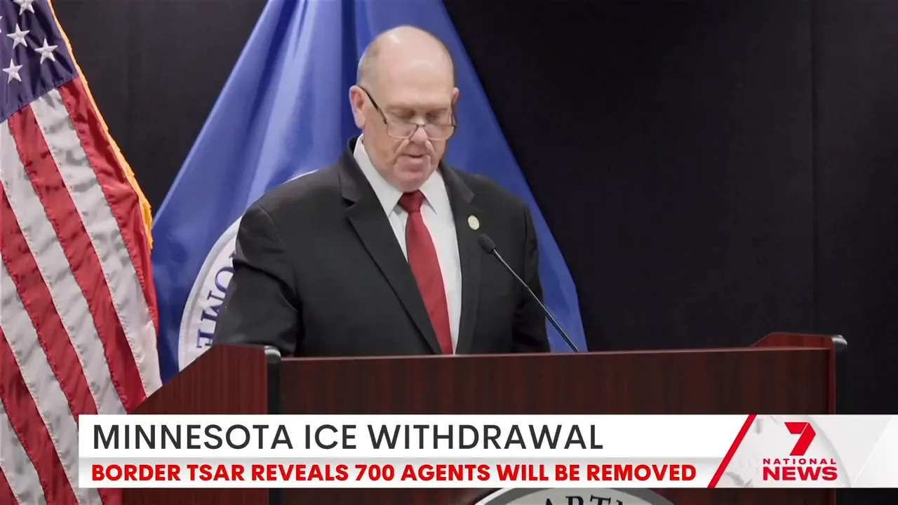 Department official at a podium announcing the reduction of 700 ICE agents; on-screen chyron reads 'MINNESOTA ICE WITHDRAWAL'.