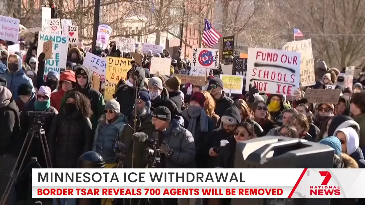 Crowd of Minnesota protesters holding signs including 'Fund our schools not ICE' and other anti‑ICE messages.