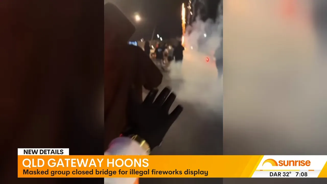 Street-level phone photo showing people on the bridge, dense smoke, a gloved hand in the foreground and fireworks in the distance during the hoon disturbance.