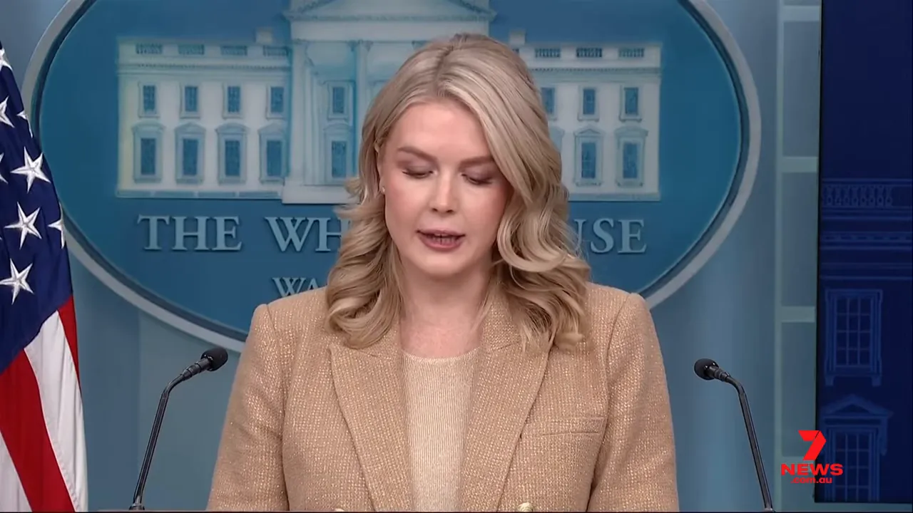 white house press briefing podium with spokesperson delivering remarks, US flag at left