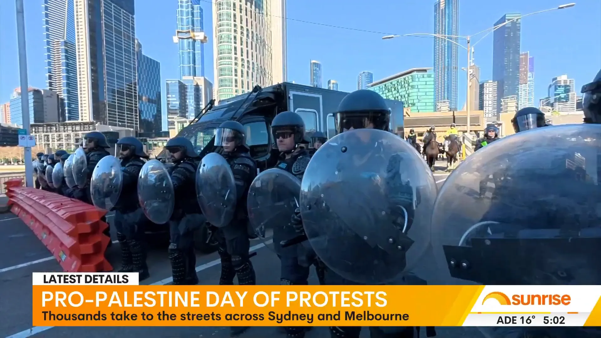 Riot gear police confronting protesters on Melbourne's King Street Bridge