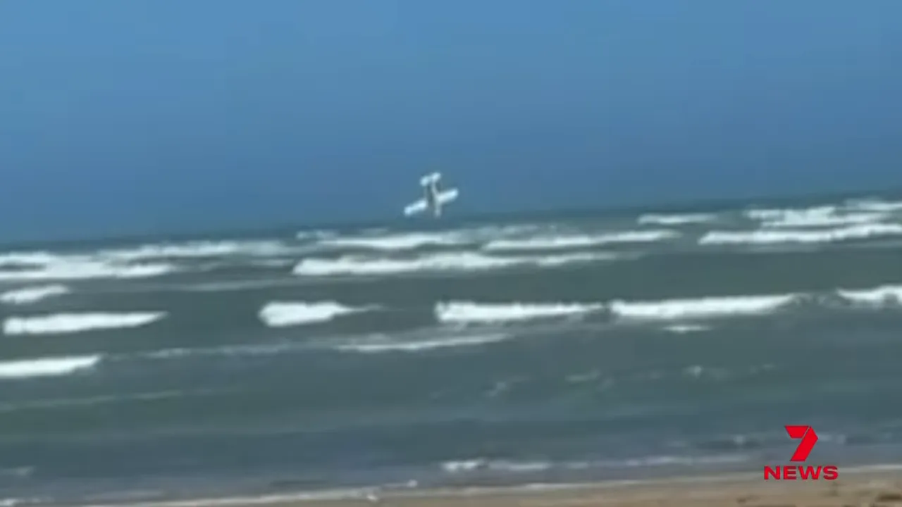 Witness video of a small aircraft in a steep nose-down attitude above the ocean with breaking waves
