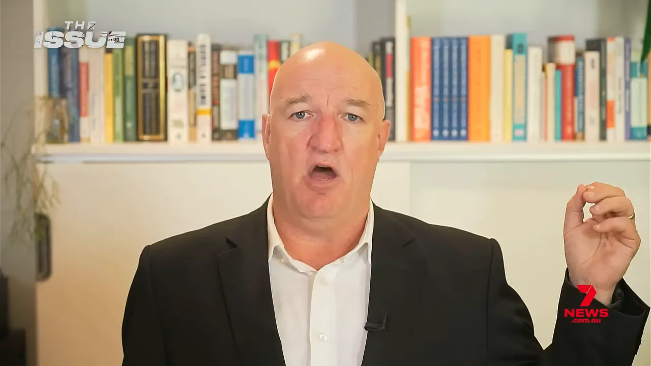 Business presenter with raised hand explaining how to maintain perspective through superannuation market drops