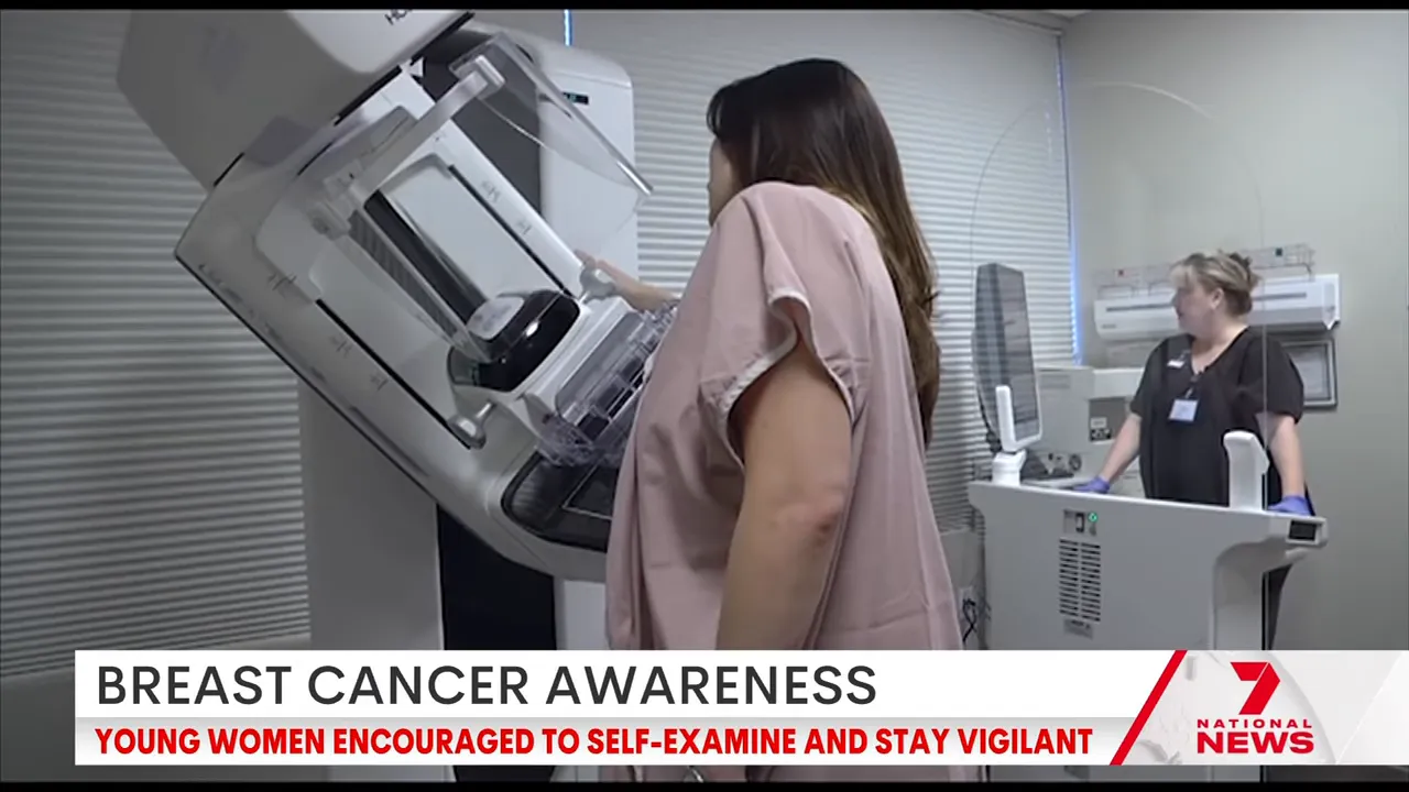 woman preparing for mammogram as technician adjusts the mammography unit in a clinic