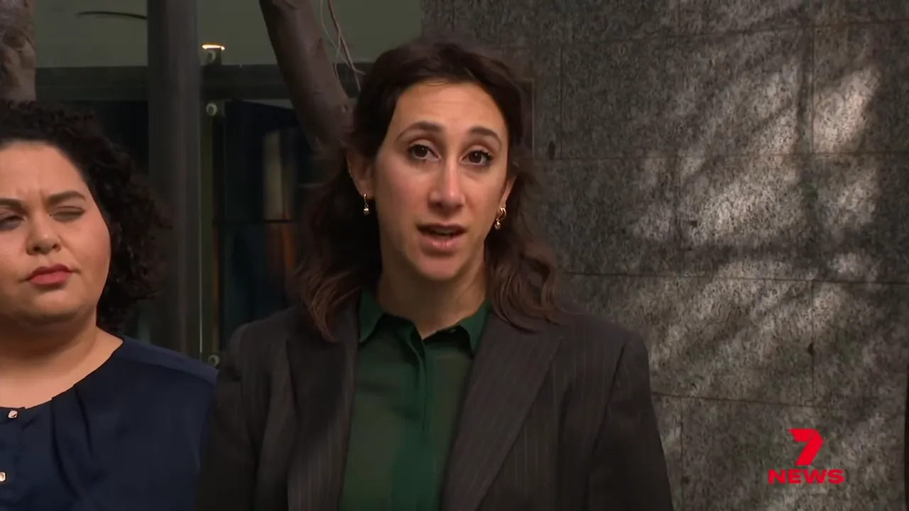 Advocate speaking at a press conference outside a courthouse about search powers