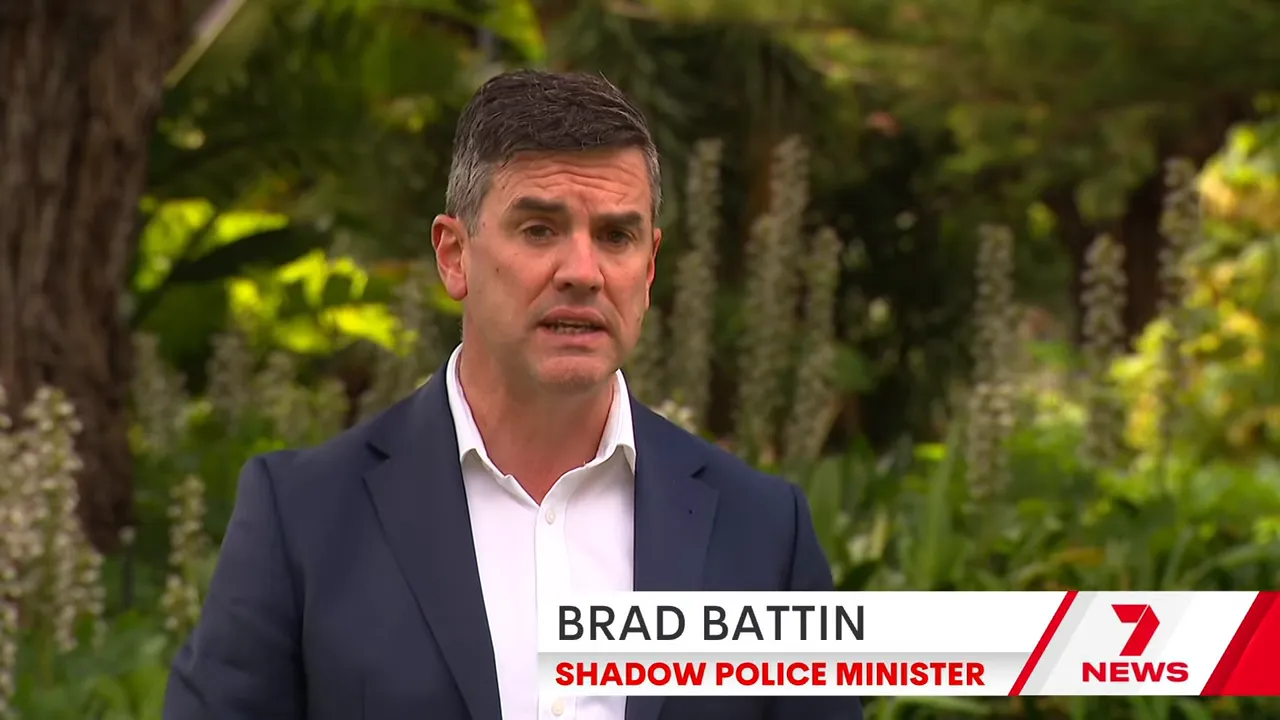 Clear outdoor shot of a male political spokesperson speaking to camera with greenery behind and a visible news lower-third.