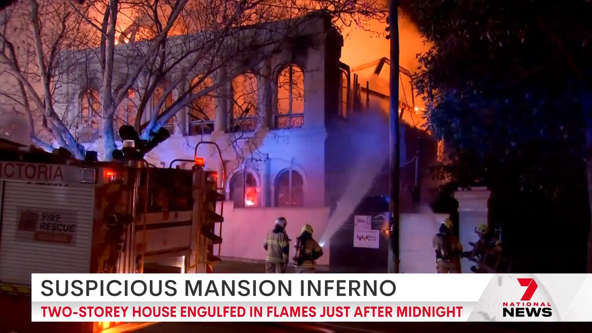 Firefighters battling intense flames from outside the mansion