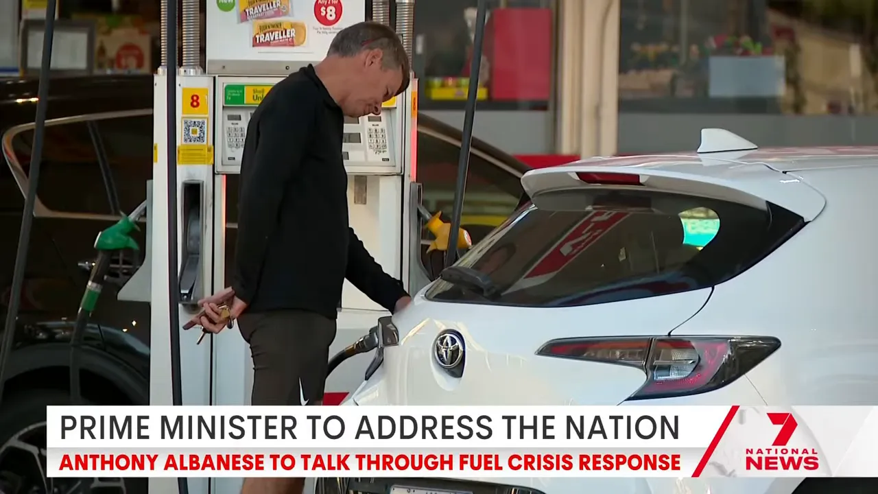 Driver pumping petrol at a station while Australia’s fuel excise cut starts