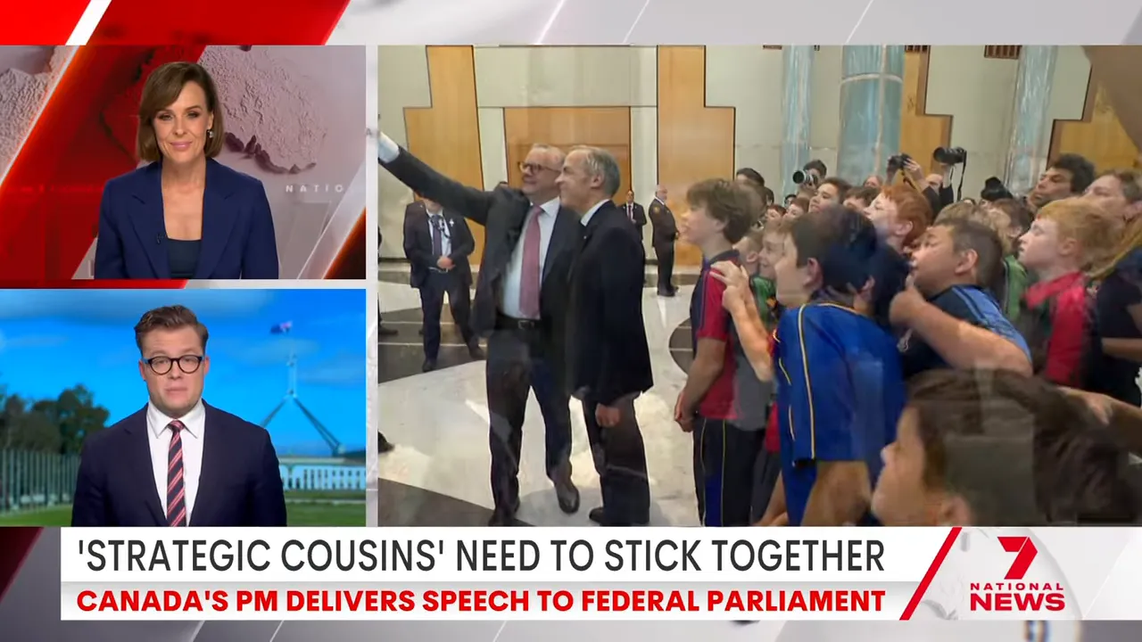 Group of schoolchildren crowded around a visiting official taking selfies in a reception area