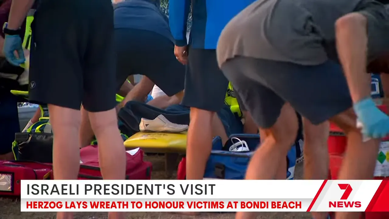 Rescuers tending to an injured person on a surfboard used as an improvised stretcher amid medical bags