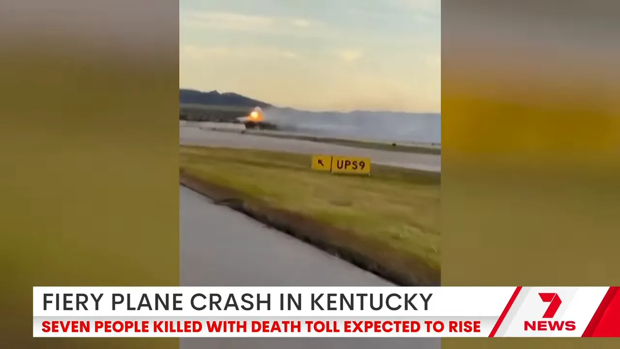 Plane climbing with fire streaming from the left wing shortly after takeoff