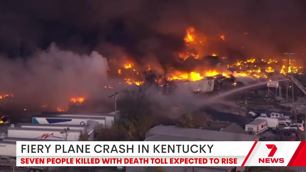 Burnt wreckage near the back of the runway showing damaged buildings