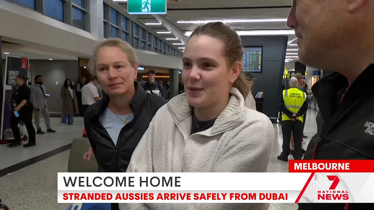 Woman and older female companion being interviewed at Melbourne airport about disrupted flights