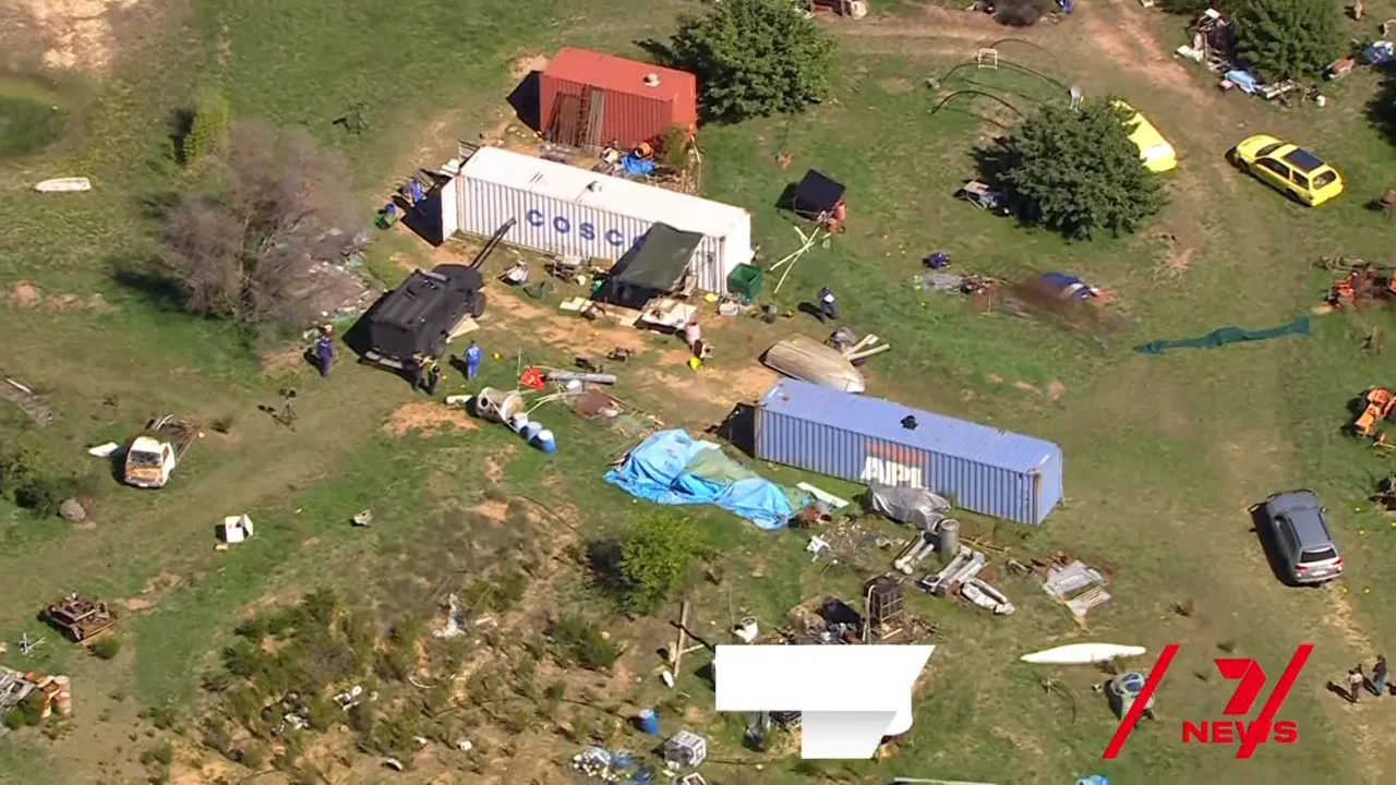 Aerial view of police investigation scene near a container at the Desi Freeman search site