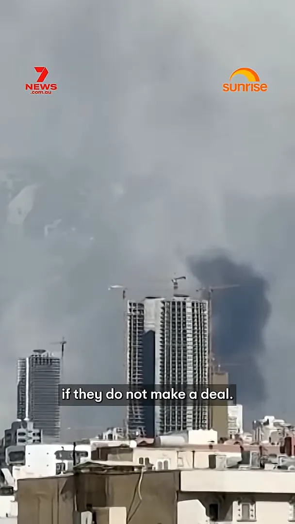 City skyline with smoke and on-screen caption text saying “if they do not make a deal”.