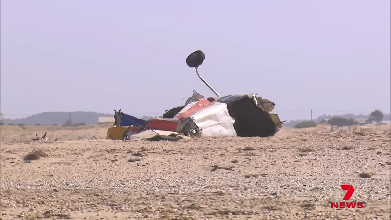 Aircraft wreckage lying on a sandy beach near Adelaide after the crash