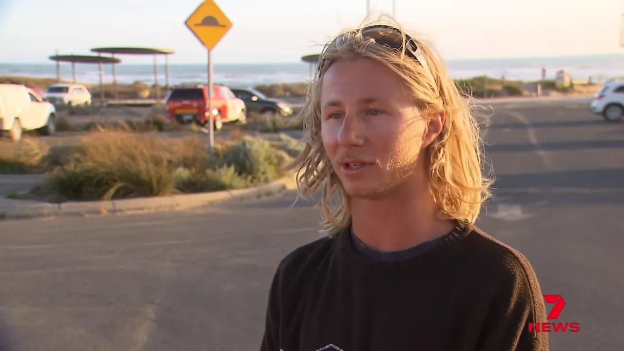 Close shot of eyewitness giving an interview about the Adelaide plane crash near the beach