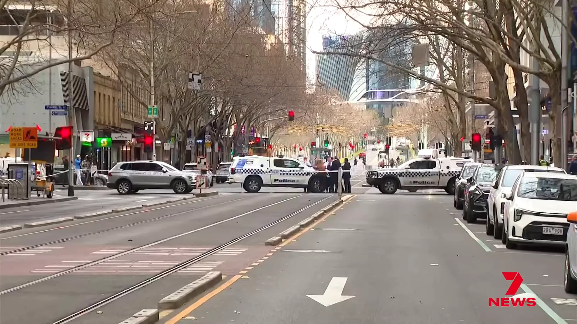 Police tape and emergency response on Elizabeth Street at dawn