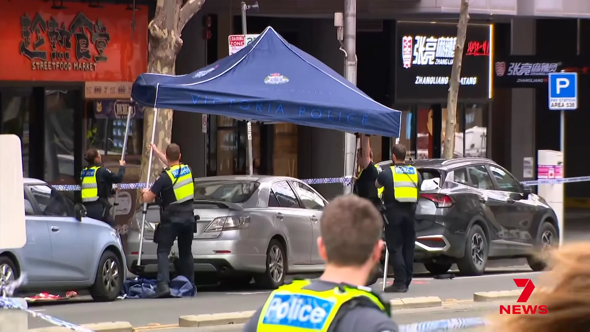 Forensic investigators examine an office chair and a Toyota sedan at the scene